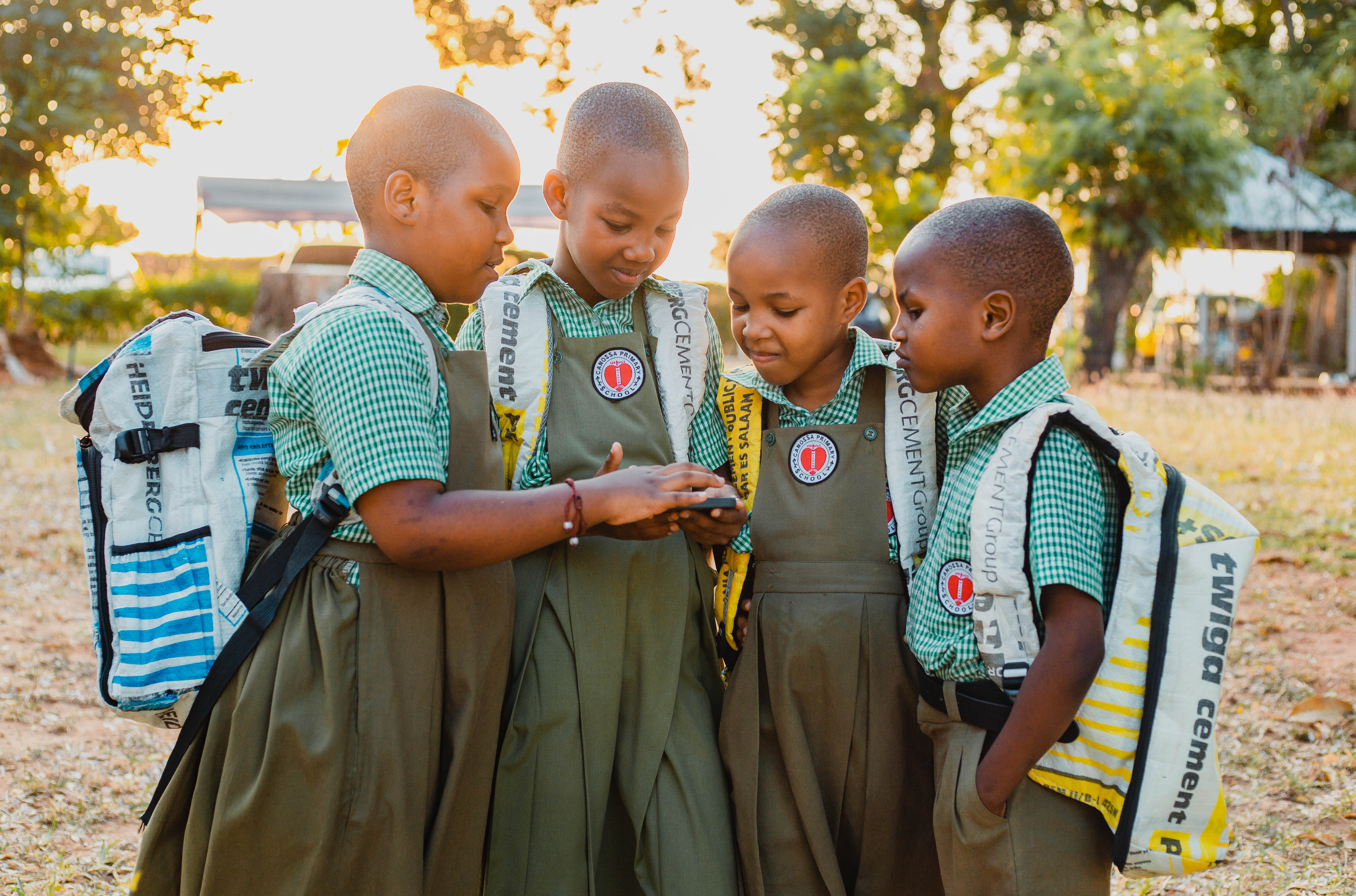 School children looking at a phone