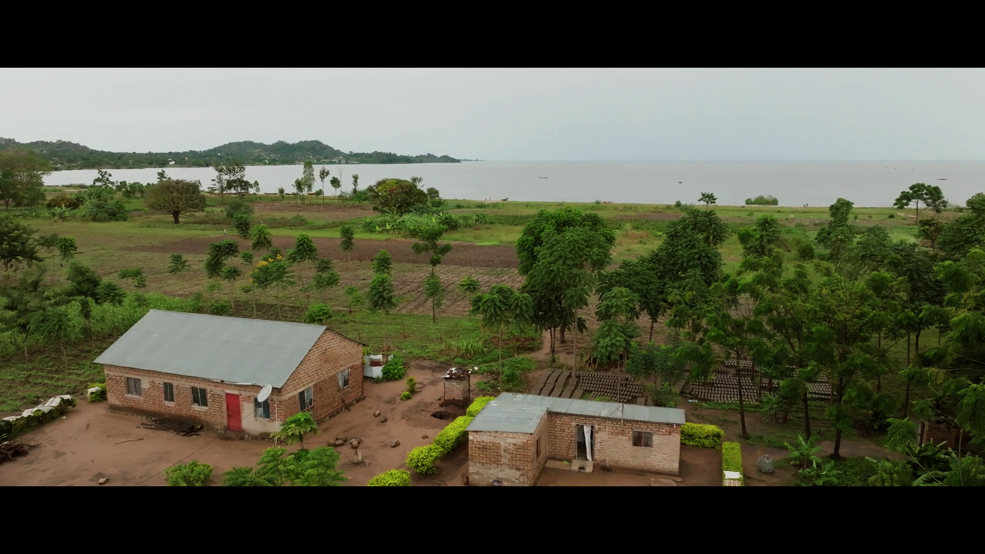DRONE VIEW OF A LAKE AND A VILLAGE